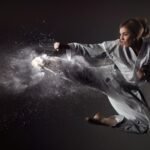 Karate girl bounces and makes a kick