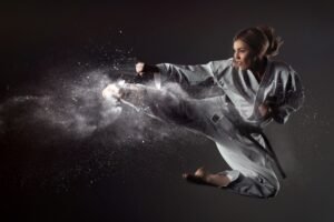 Karate girl bounces and makes a kick